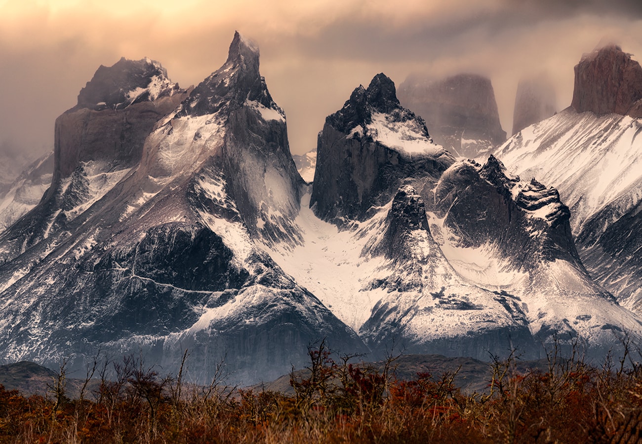 torres del paine is covered by snow during the sunset