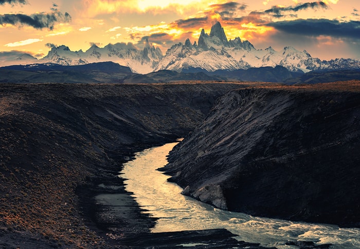 he Fitz Roy river flowing in bends beneath our feet leading the sight towards towers of Fitz Roy (Chalten) massif.