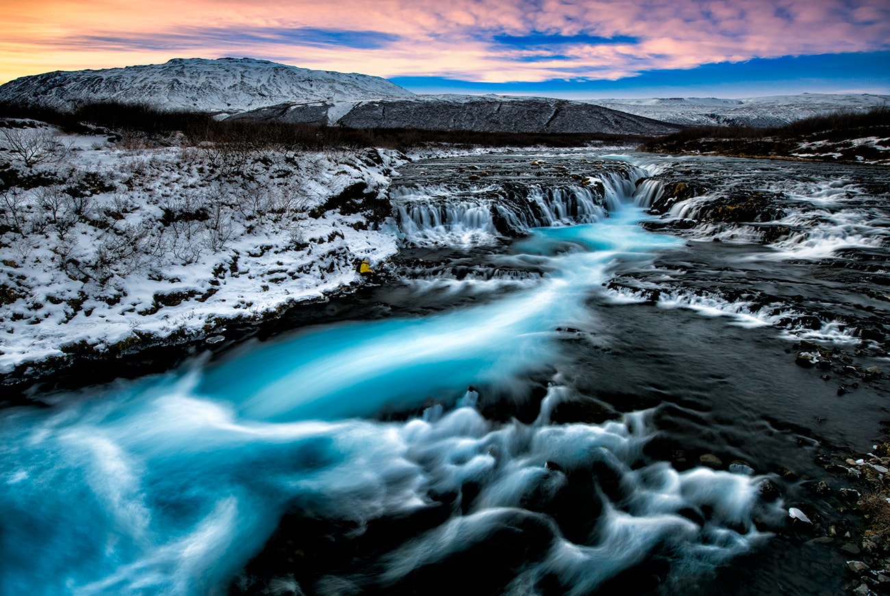 is a relatively small waterfall compared to many of its Icelandic counterparts, but its diminutive size does nothing to take away from its staggering beauty. Both locals and seasoned travellers regard Brúarfoss as one of the country’s hidden gems, often labelling it 'Iceland’s Bluest Waterfall.'