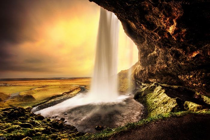 Seljalandsfoss is a waterfall that can be fully encircled, situated on the South Coast of Iceland with a drop of 60 metres (200 feet). Due to the waterfall’s close proximity to the Ring Road and impressive natural features, it is one the country's most famous and visited falls. Majestic and picturesque, it is one of the most photographed features in all of Iceland.